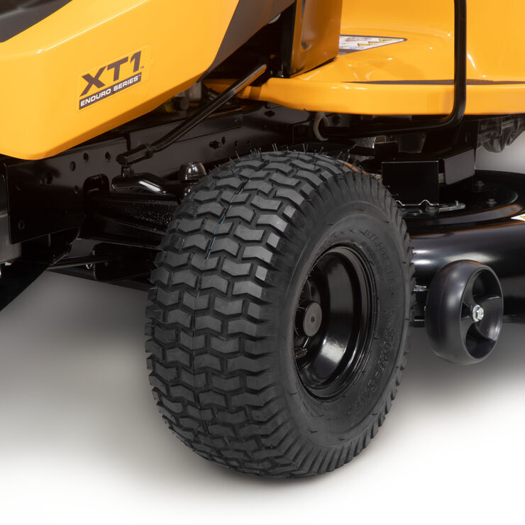 Close-up of a yellow lawn mower with 'XT1' branding on a white background
