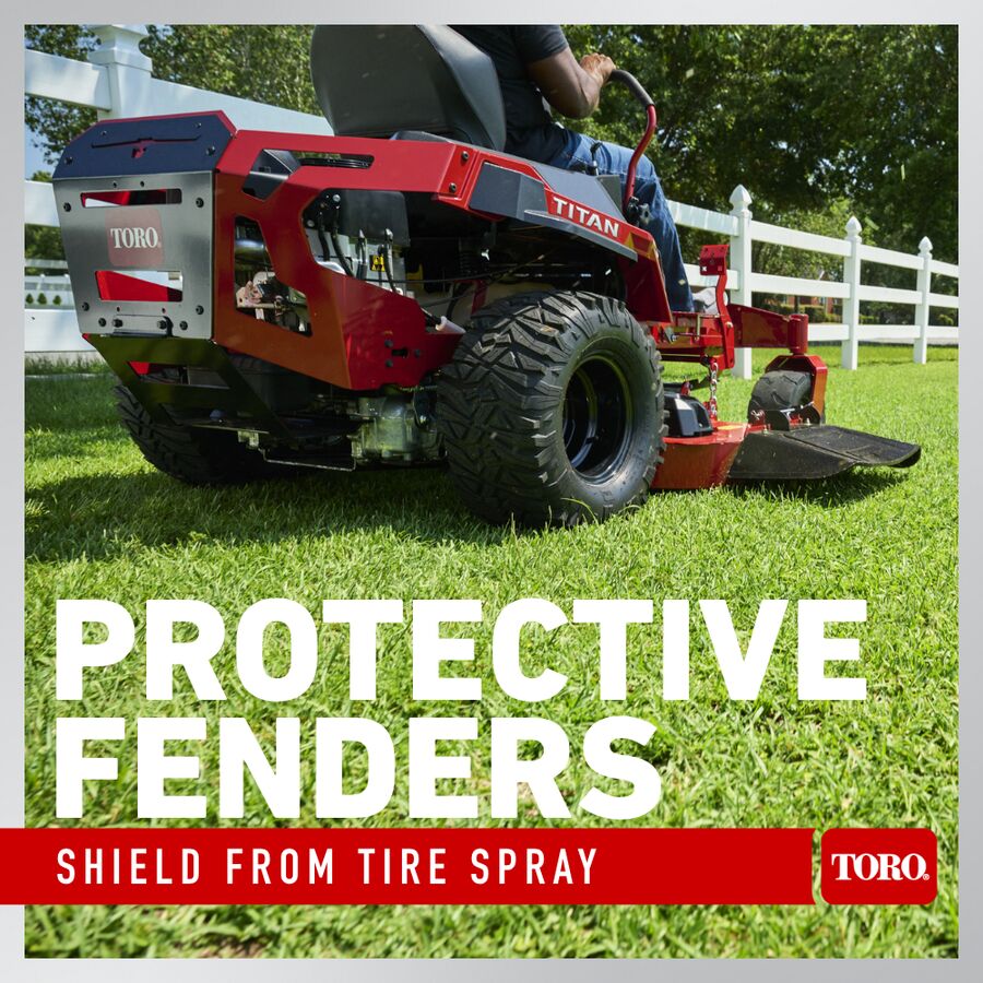 Red Toro lawn mower with protective fenders on a grassy area, text highlighting fender features.
