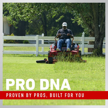 Man operating a lawn mower in a grassy area with trees and a white fence in the background, featuring the 'Pro DNA' brand text.