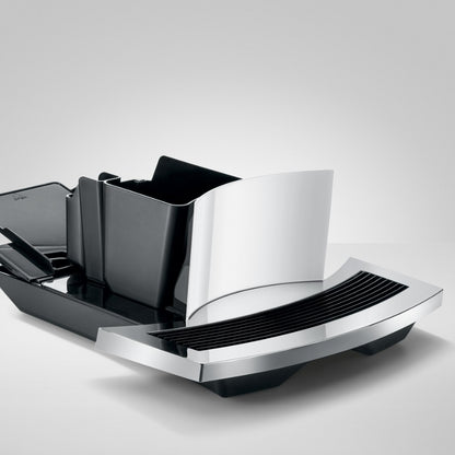 Modern kitchen knife block with black and silver design on a light gray background