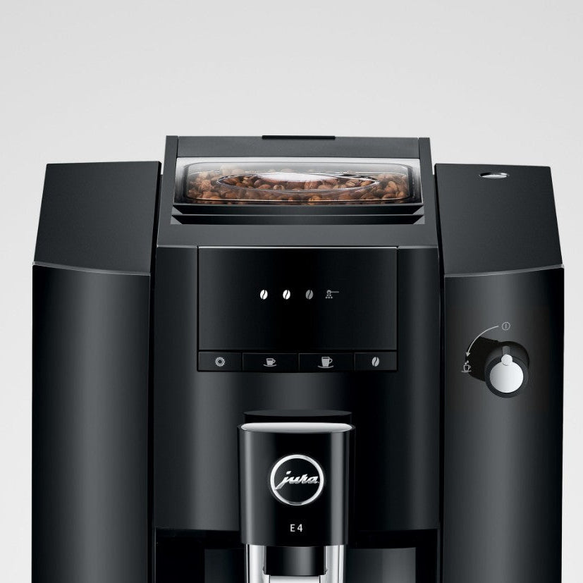Black coffee machine with visible brand logo on a light gray background