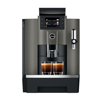Modern coffee machine with two cups of coffee on a white background