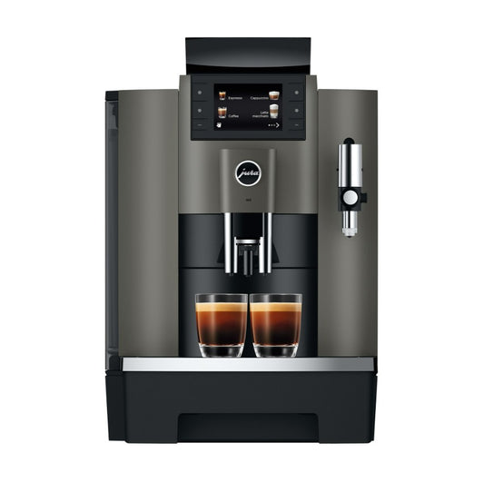 Modern coffee machine with two cups of coffee on a white background