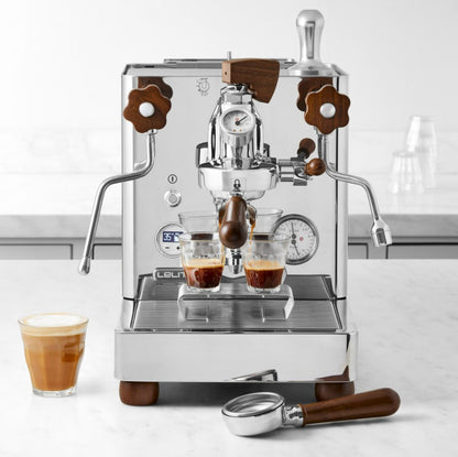Leva espresso machine with two cups of coffee on a white surface