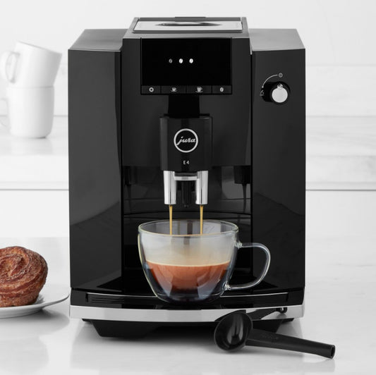 Black coffee machine making a cup of coffee on a white background