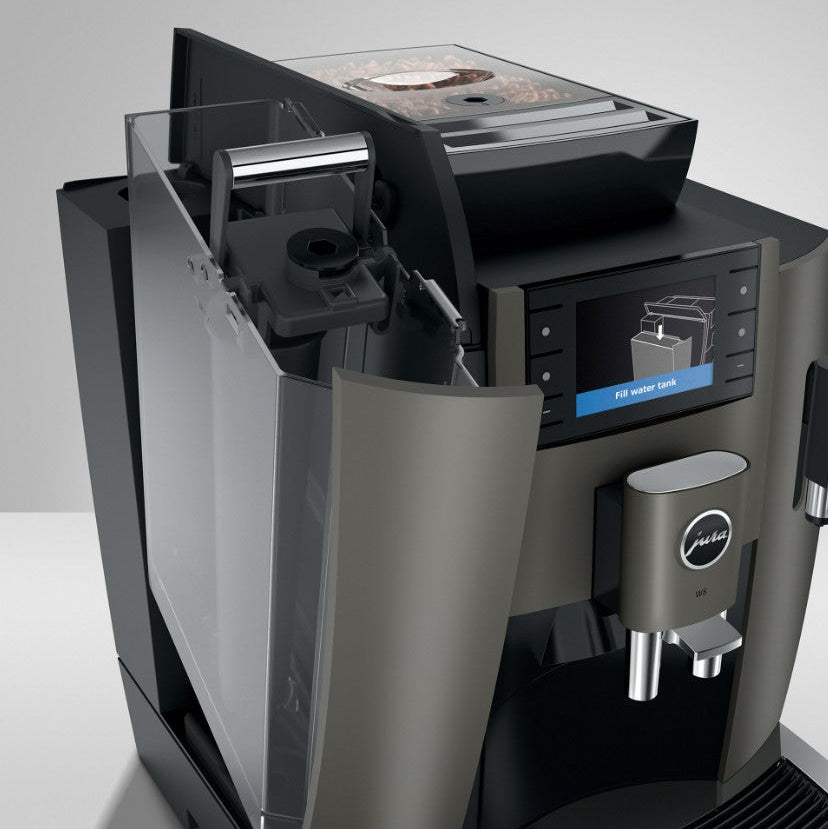 Coffee machine with a transparent water tank on a white background