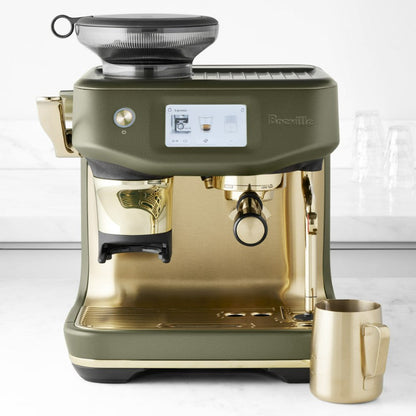 Green and gold Breville coffee machine on a white background