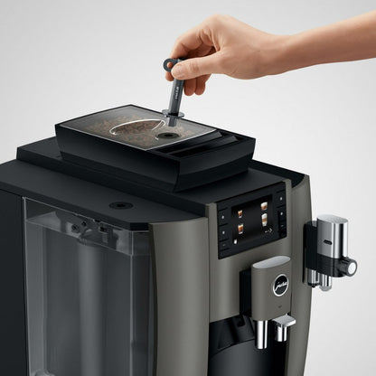 Hand using a coffee machine with a white background