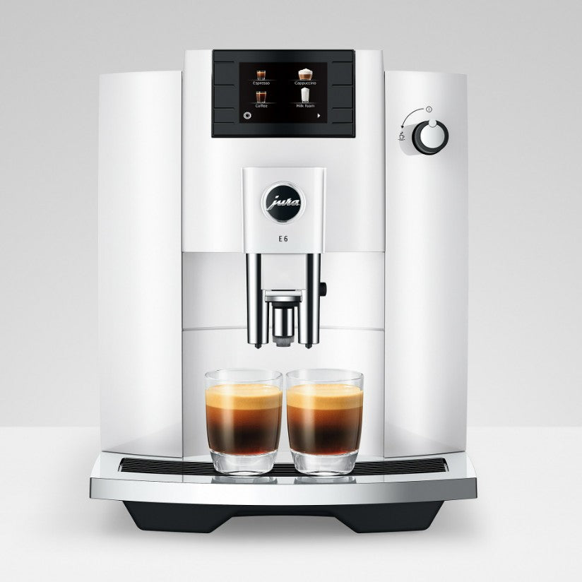 Modern coffee machine with two glasses of coffee on a white background