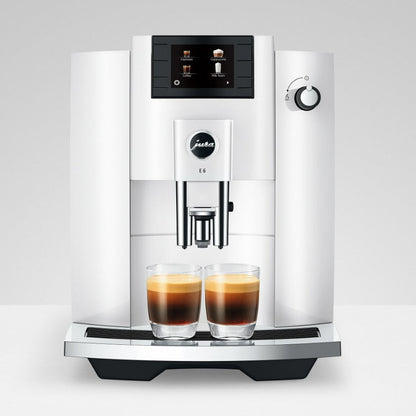 Modern coffee machine with two glasses of coffee on a white background