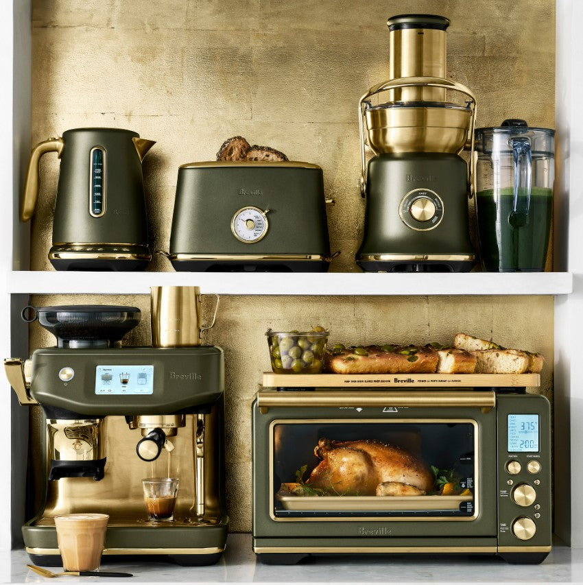 Collection of kitchen appliances including a coffee machine, toaster, juicer, and oven on a wooden shelf.
