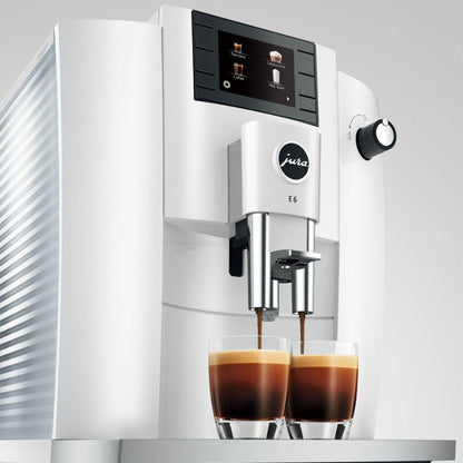 Jura coffee machine dispensing coffee into two glasses on a white background