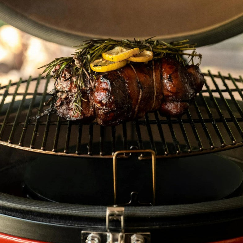Grilled meat with lemon and herbs on a barbecue grill