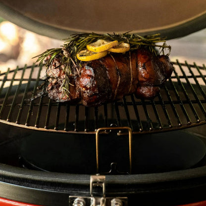 Grilled meat with lemon and herbs on a barbecue grill