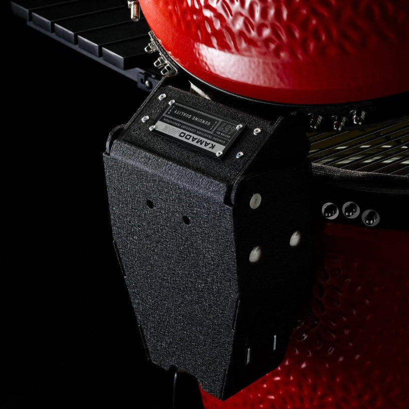 Black kamado grill starter with a red kamado grill on a black background