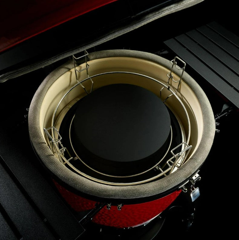 Close-up of a red and black drum with a circular metallic object inside