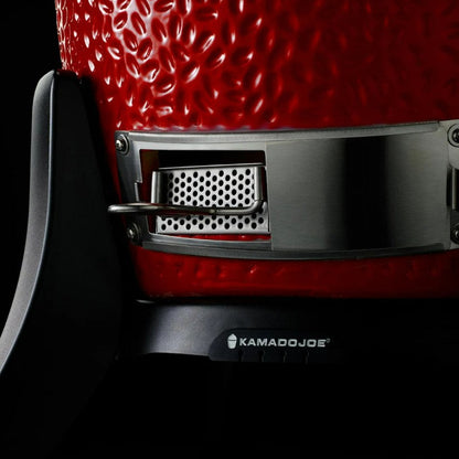 Close-up of a red Kamado Joe grill with visible branding.