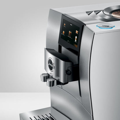 Stainless steel coffee machine with digital display on a white background