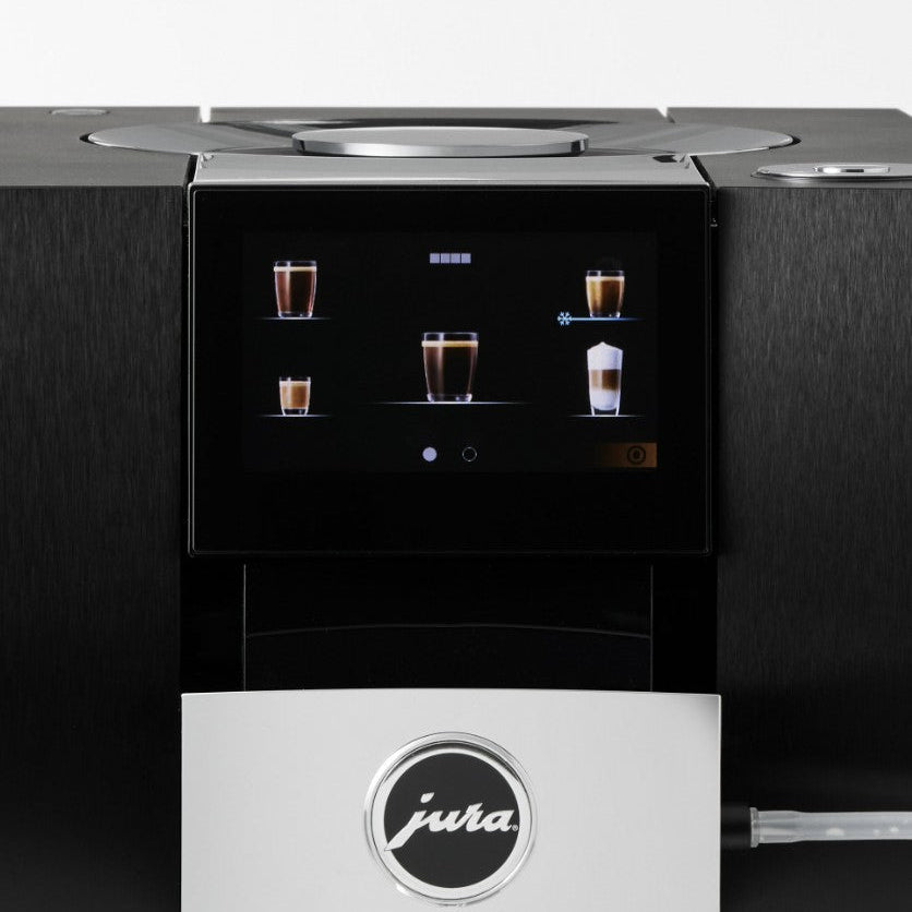 Jura coffee machine with a display screen showing coffee cup graphics on a dark background