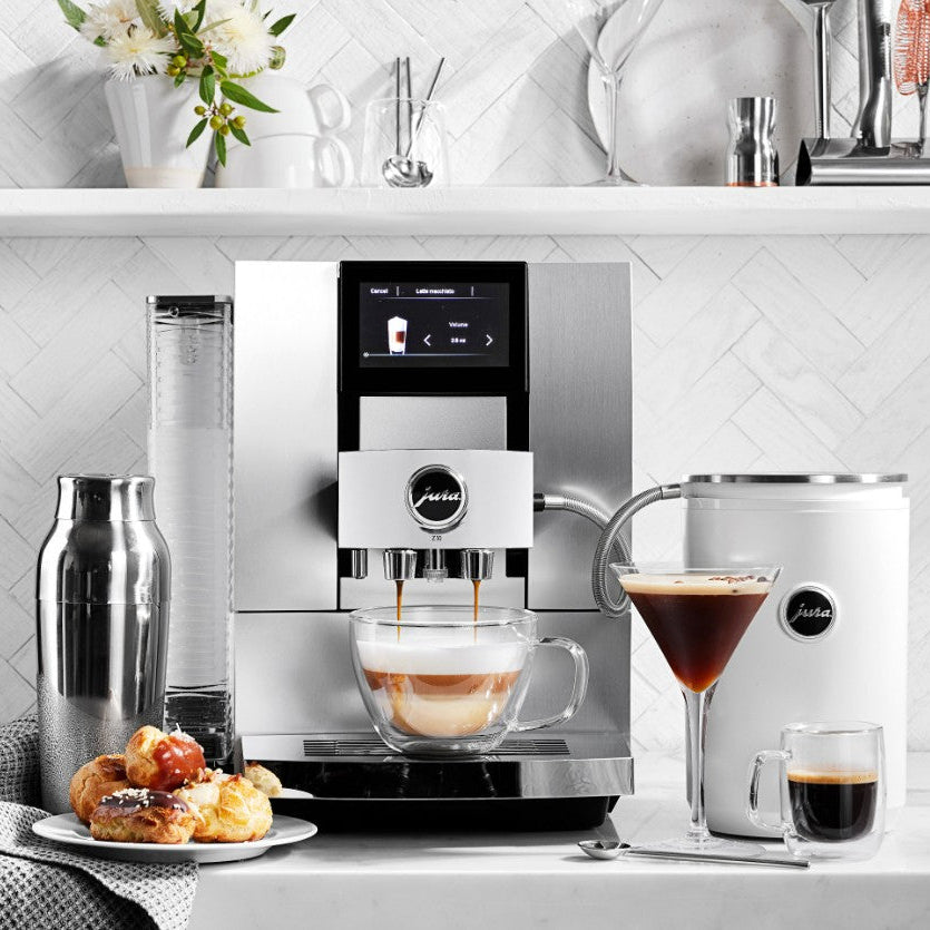 Modern coffee machine with a cup of coffee on a kitchen counter.