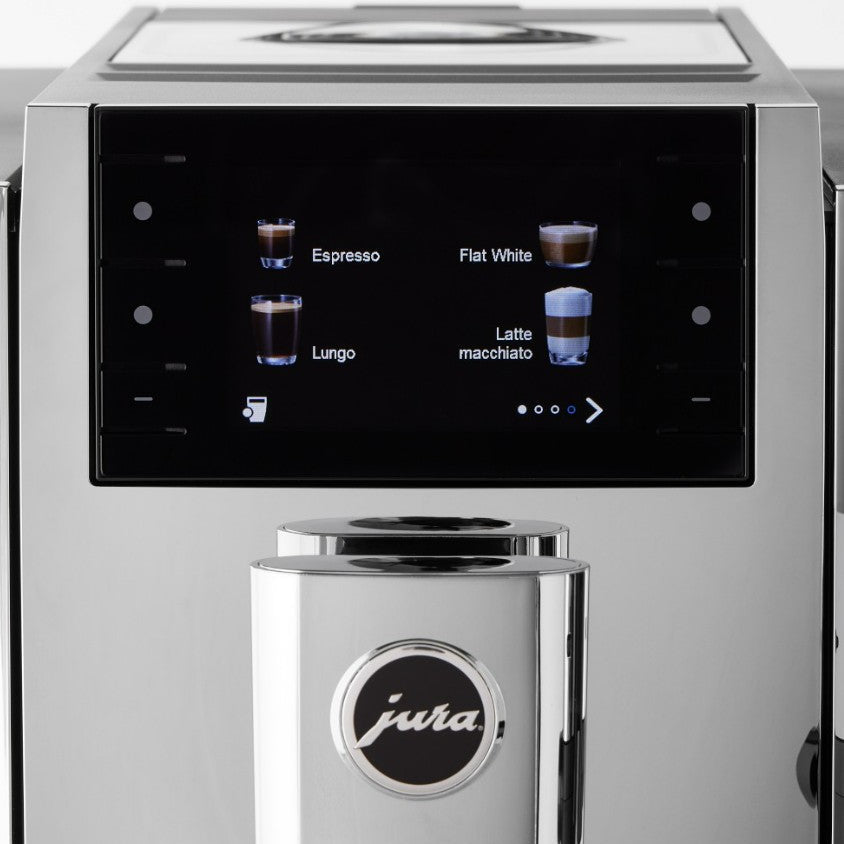 Silver coffee machine with digital display showing coffee types on a black background