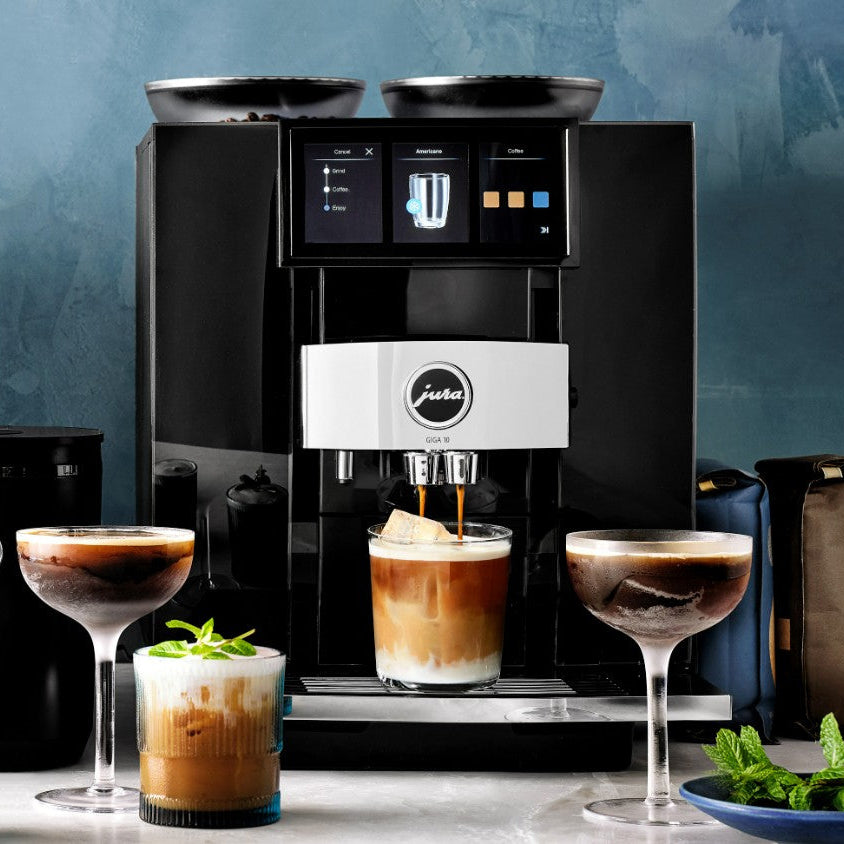 Jura coffee machine with glasses of coffee and a blue background