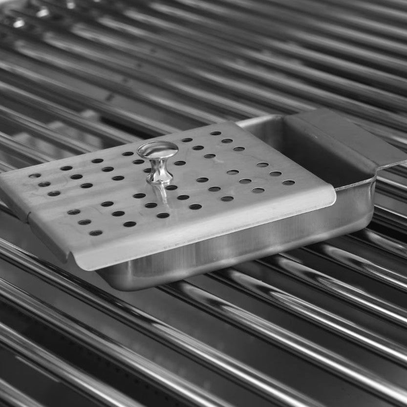Stainless steel grill cleaning brush on a grill surface