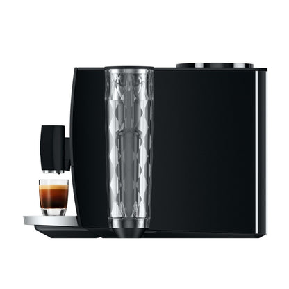 Black coffee machine with a glass of coffee on a white background