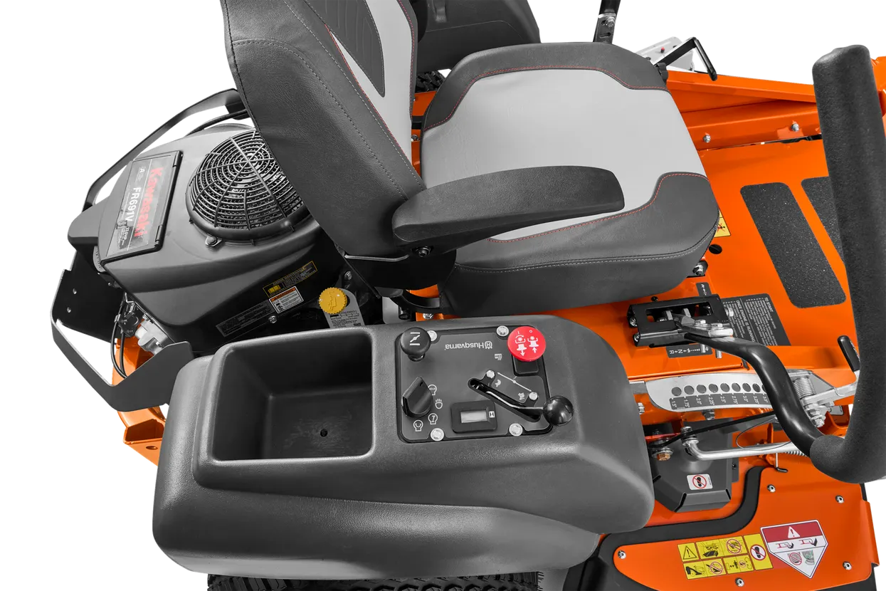 Close-up of a lawn mower seat and control panel on an orange machine.