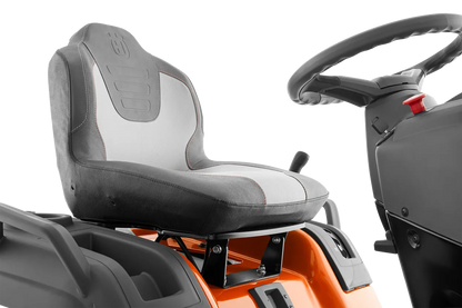 Close-up of a tractor seat and steering wheel on a white background