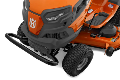 Close-up of an orange lawn mower with a visible Husqvarna logo on a white background